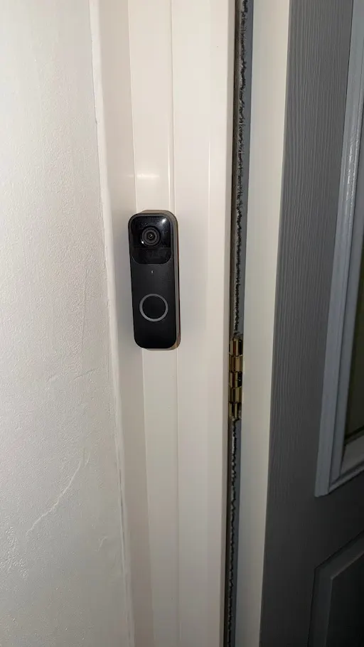 Smart doorbell camera on door frame